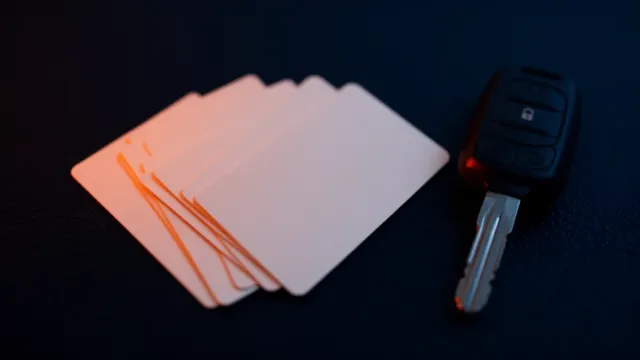 Varias tarjetas de gasoil en abanico junto a una llave de camión sobre una superficie oscura, iluminadas con luz naranja
